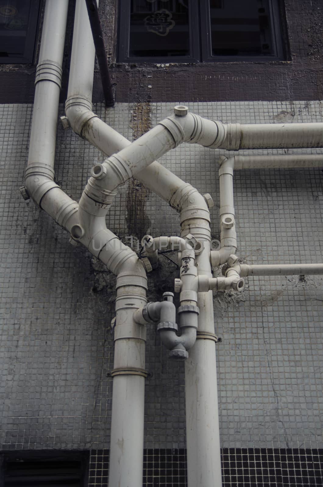 Old grunge building structure with pipes. Urban background