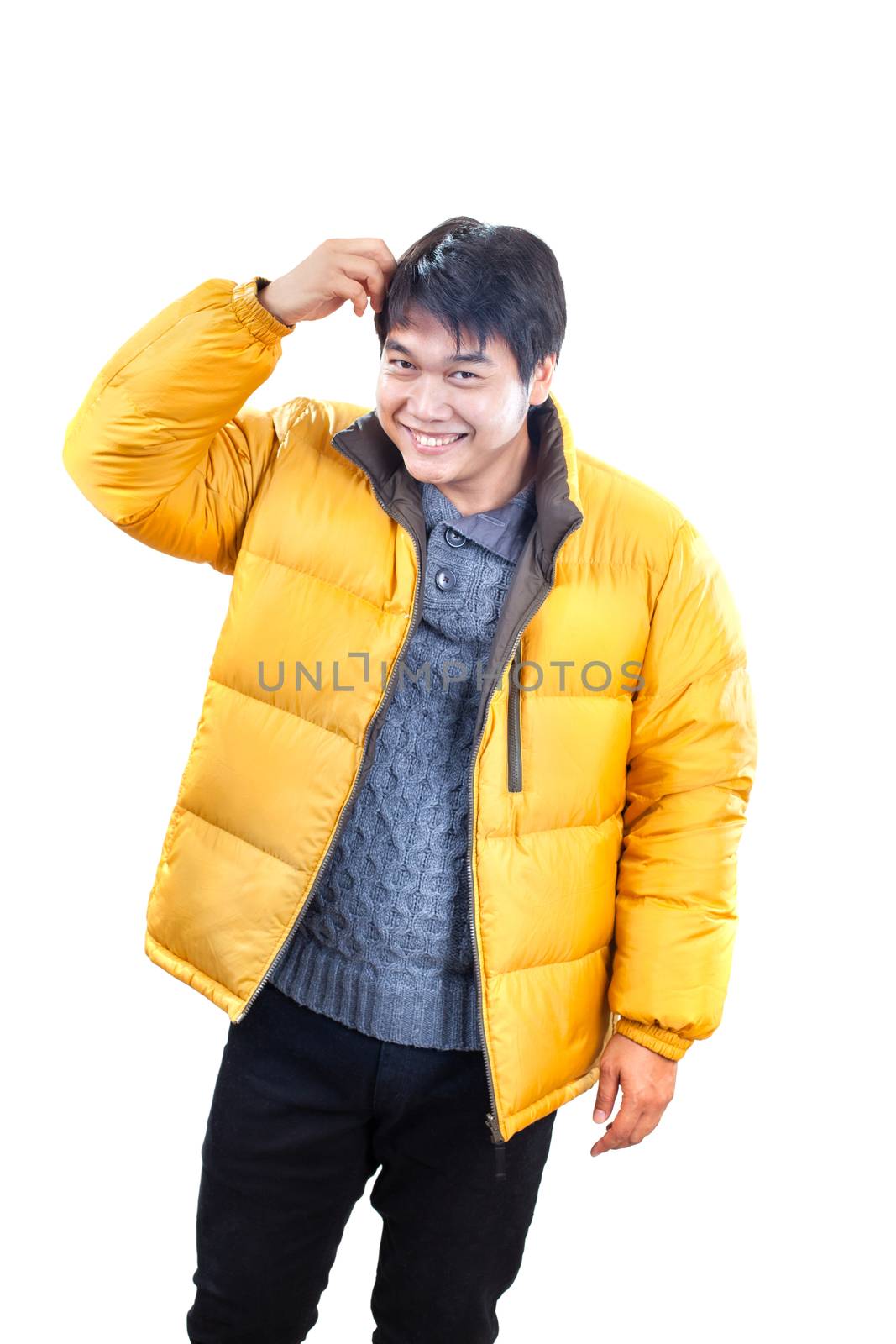 portrait of young asian man wearing yellow winter jacket and bla by khunaspix