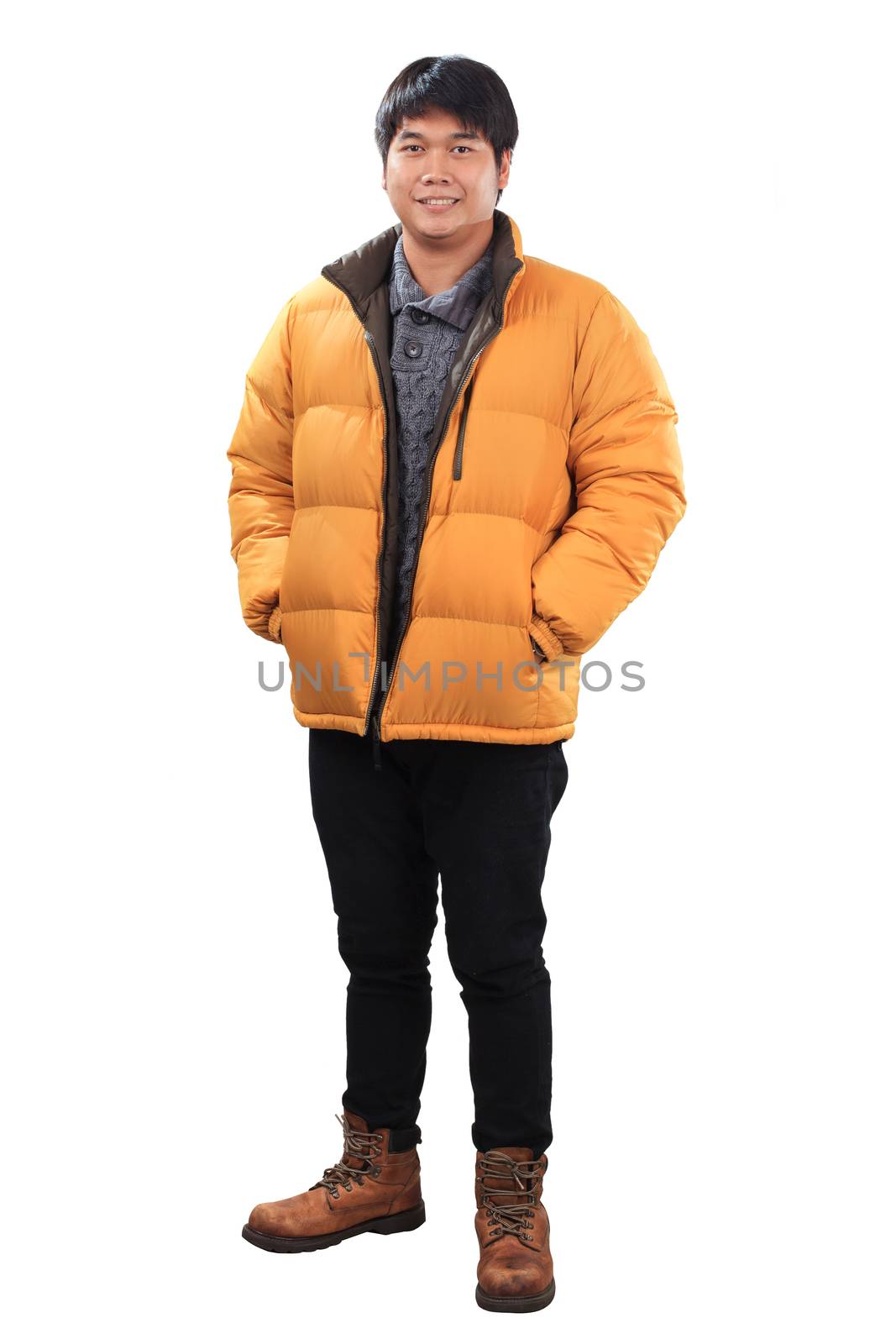 portrait of young asian man wearing yellow winter jacket and black jeans leather shoes standing with smiling face isolated white background
