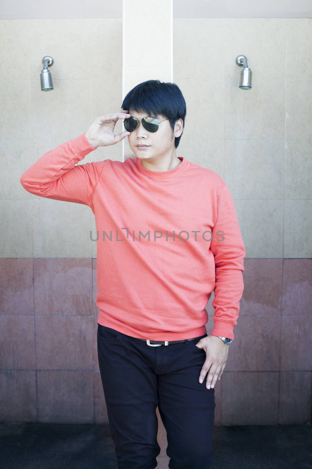 young smart man wearing sun glasses lean building wall good look by khunaspix