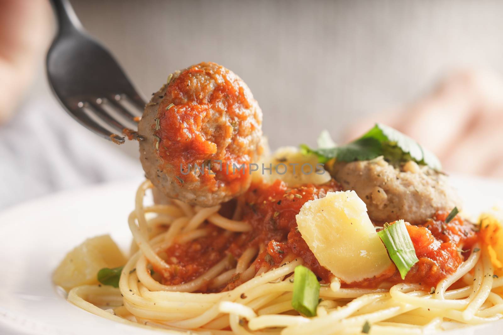 Woman eating spaghetti with meatballs horizontal close up
