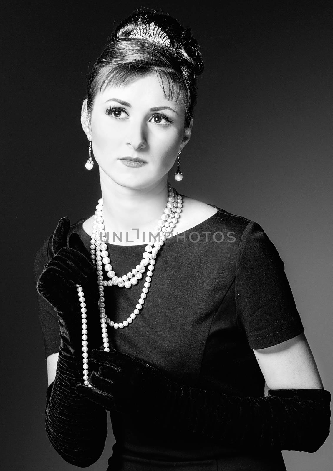 vintage Portrait of a beautiful young elegant woman. The girl in the image of Audrey Hepburn. Black and white photography