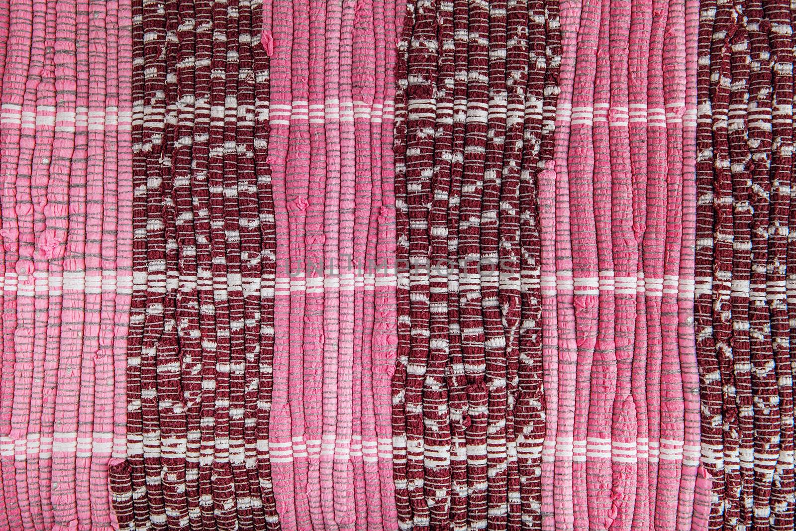background, texture of colored handmade carpet. Fabric rug of small patches