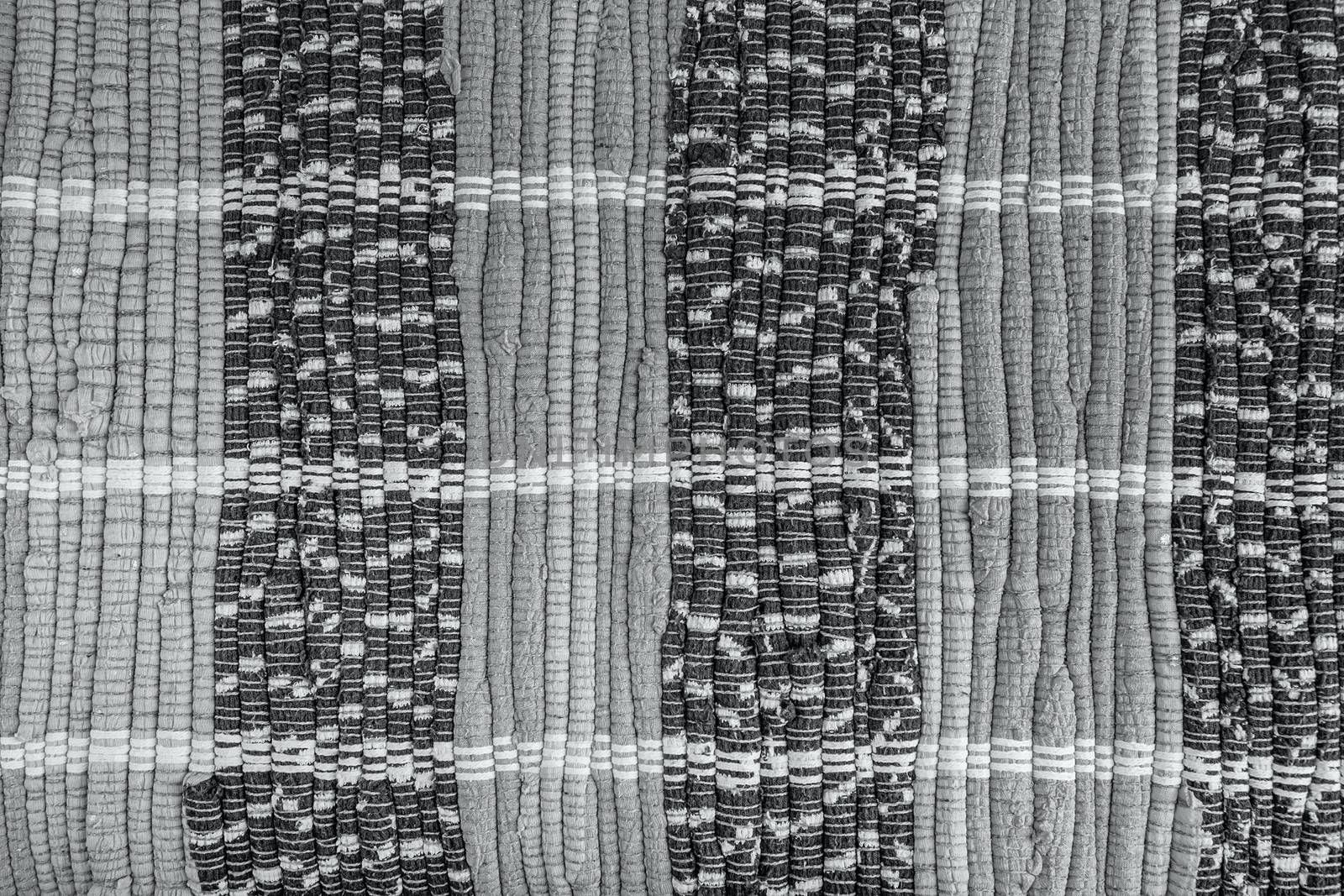 background, texture of colored handmade carpet. Fabric rug of small patches