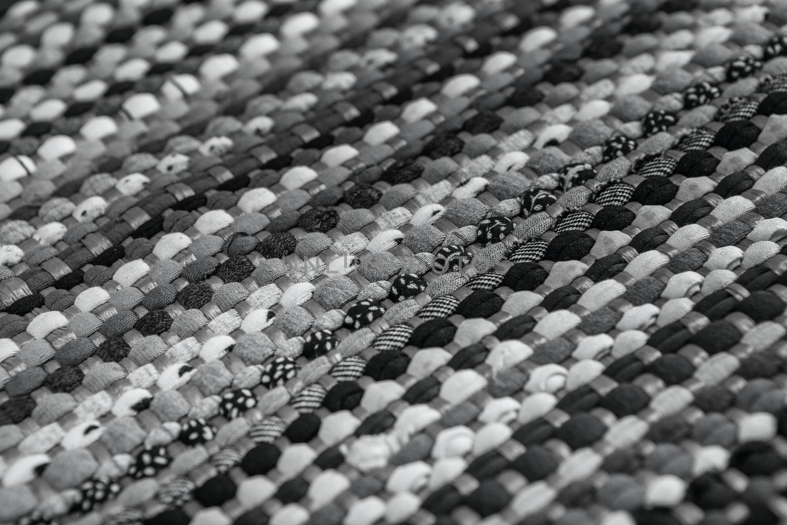 background, texture of colored handmade carpet. Fabric rug of small patches