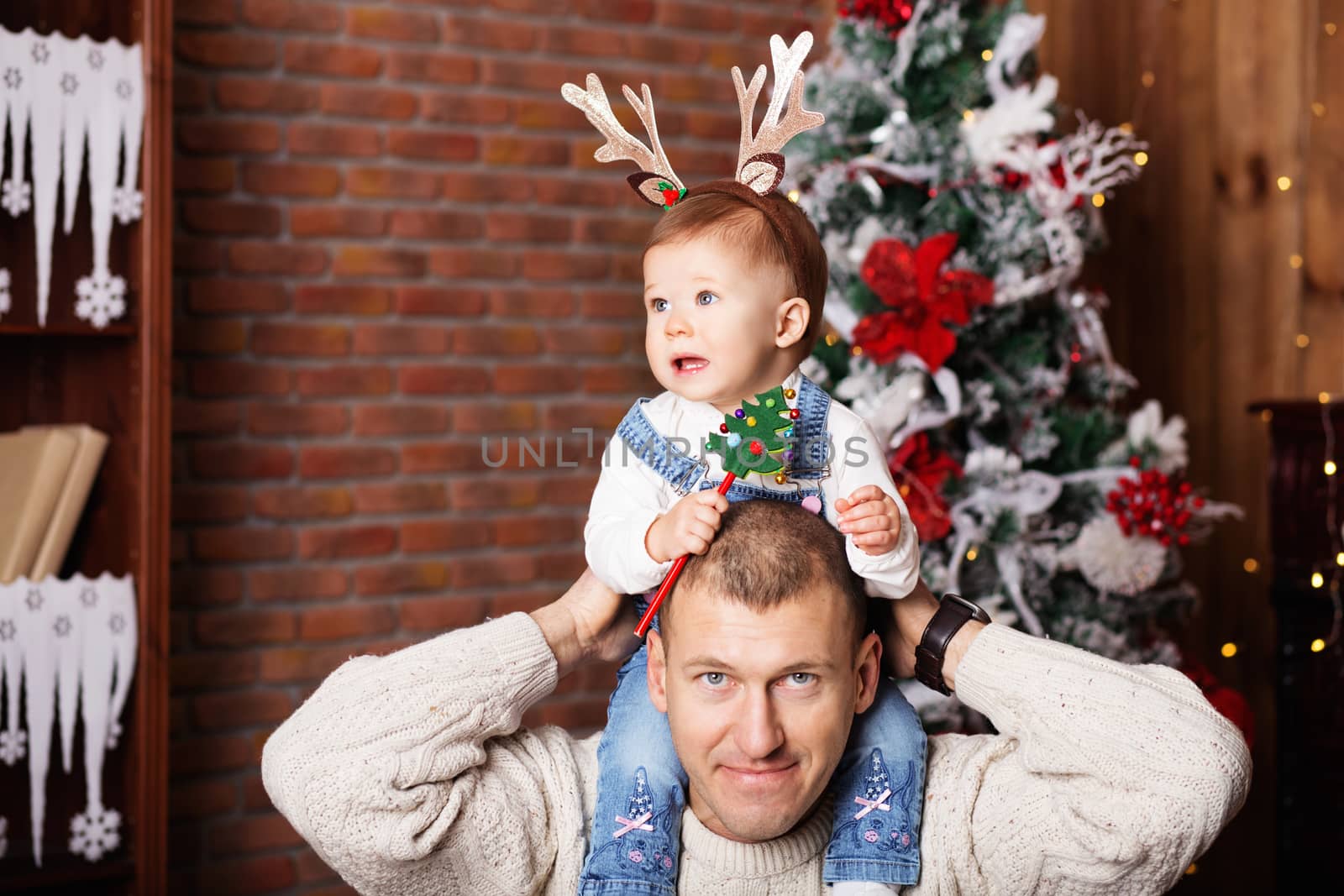 happy father and his adorable little daughter among Christmas de by natazhekova