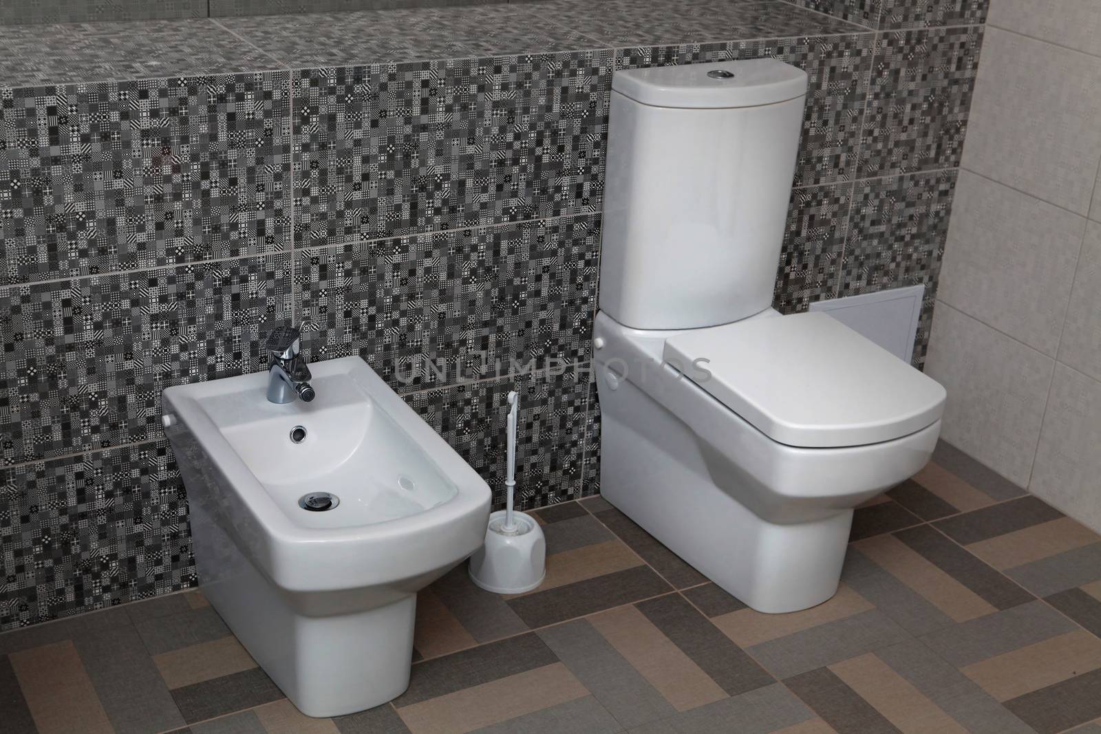 white toilet and bidet in a modern bathroom