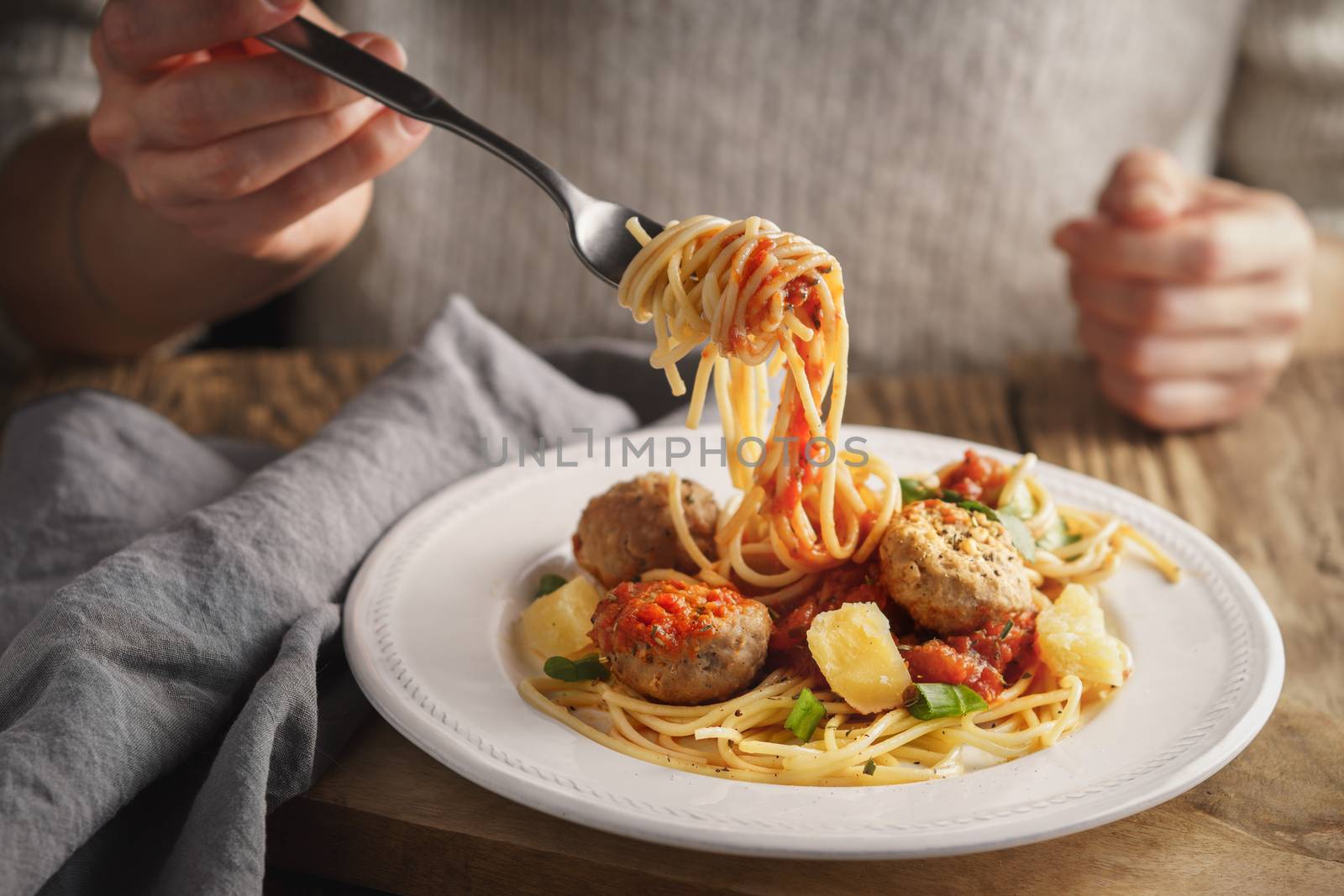 Woman eating spaghetti with meatballs and cheese by Deniskarpenkov