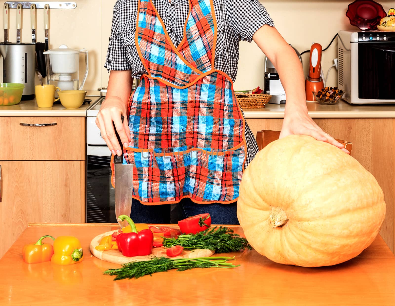 Housewife ready to prepare big pumpkin