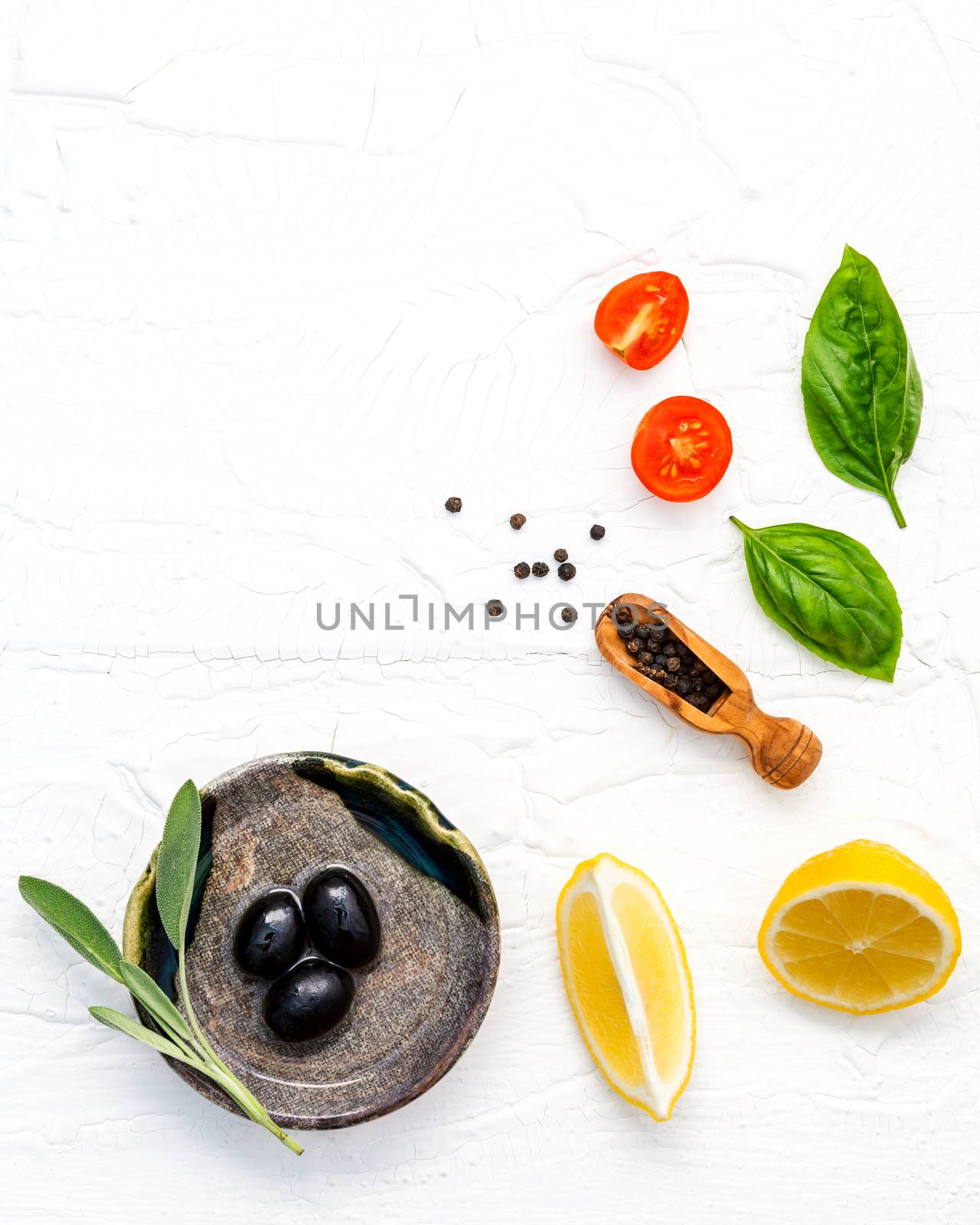 Food background with fresh herbs  tomato ,lemon slice , black pe by kerdkanno