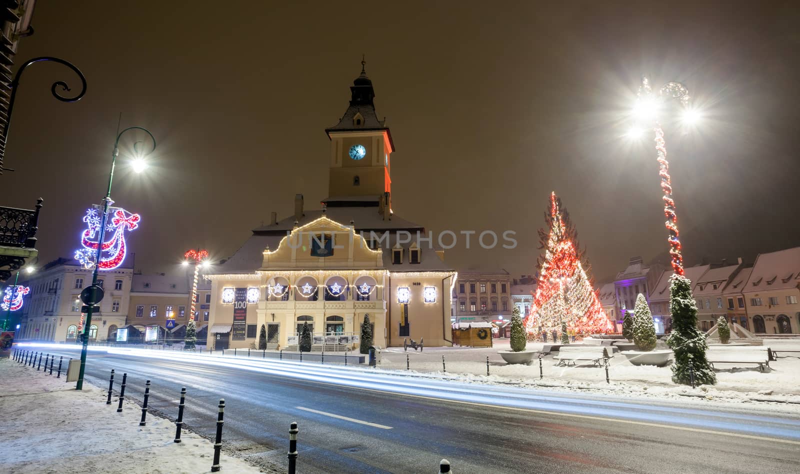 BRASOV, ROMANIA - 15 DECEMBER 2016: Brasov Council House night view with Christmas Tree decorated and traditional winter market in the old town center, Romania