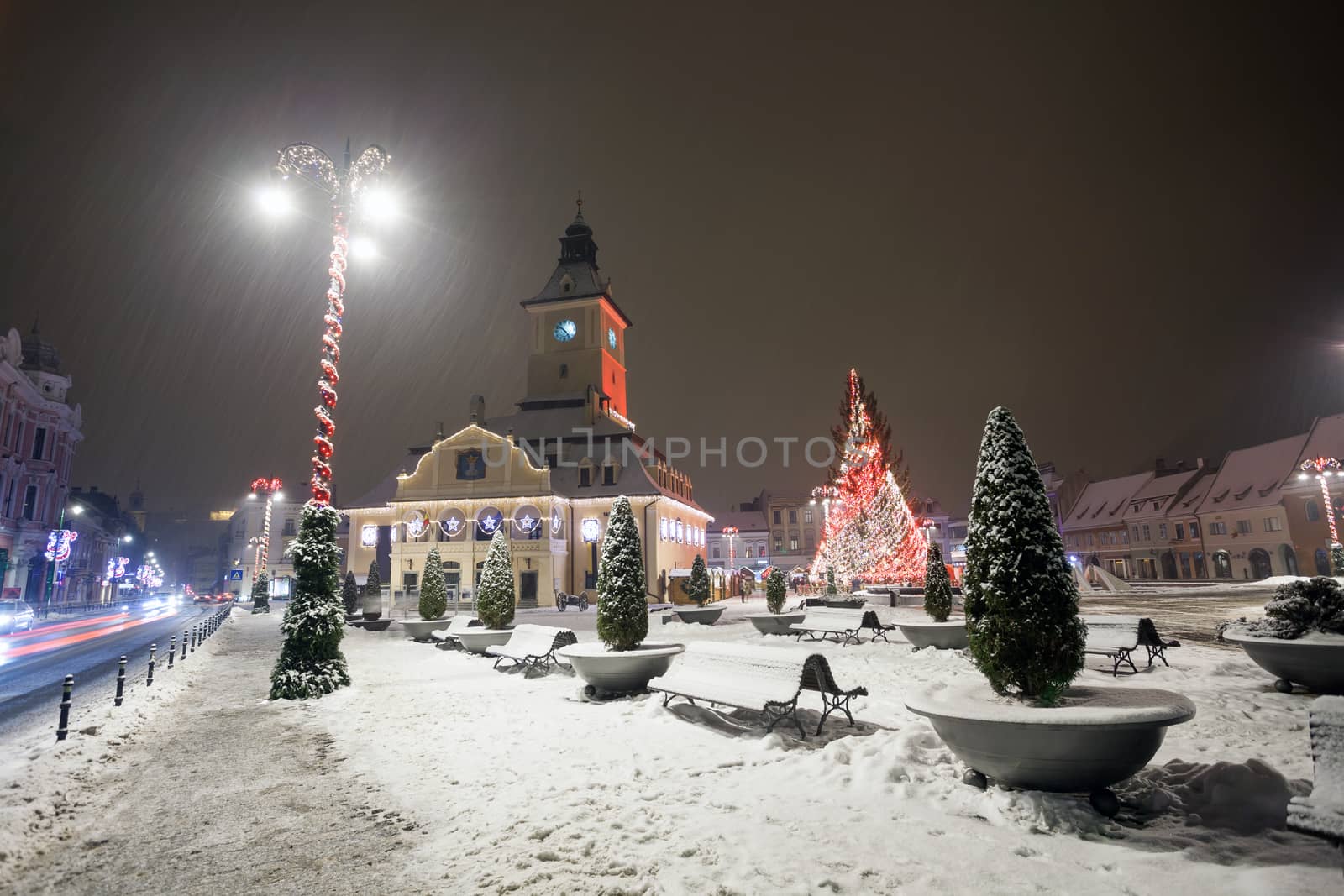 Brasov Council House night view decorated for Christmas and traditional winter market in the old town center, Romania