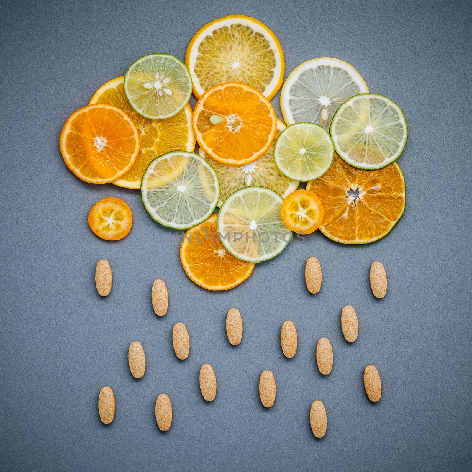 Healthy foods and medicine concept. Pills of vitamin C and citru by kerdkanno