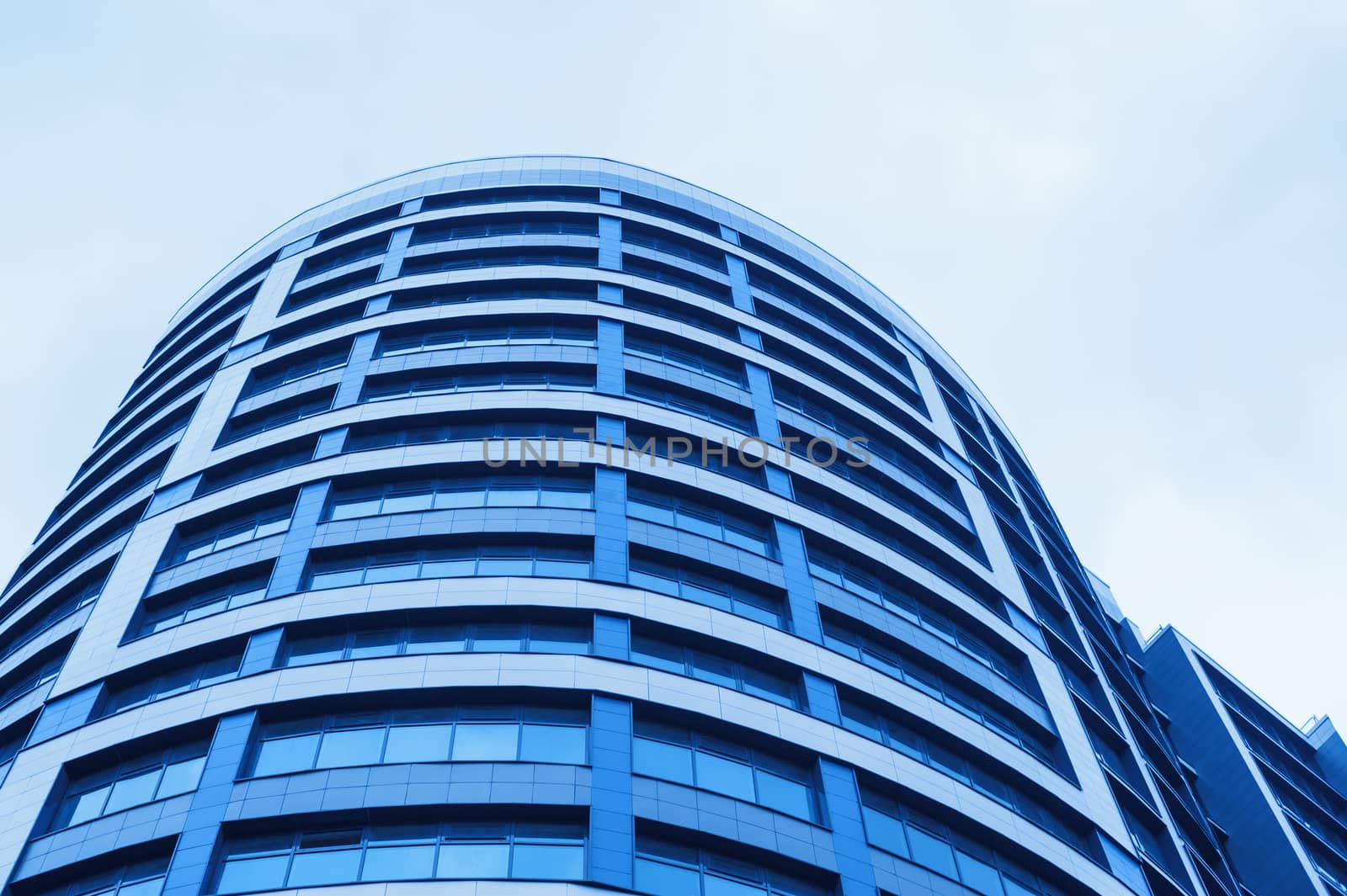 blue glass office building skyscraper on background of skyline.