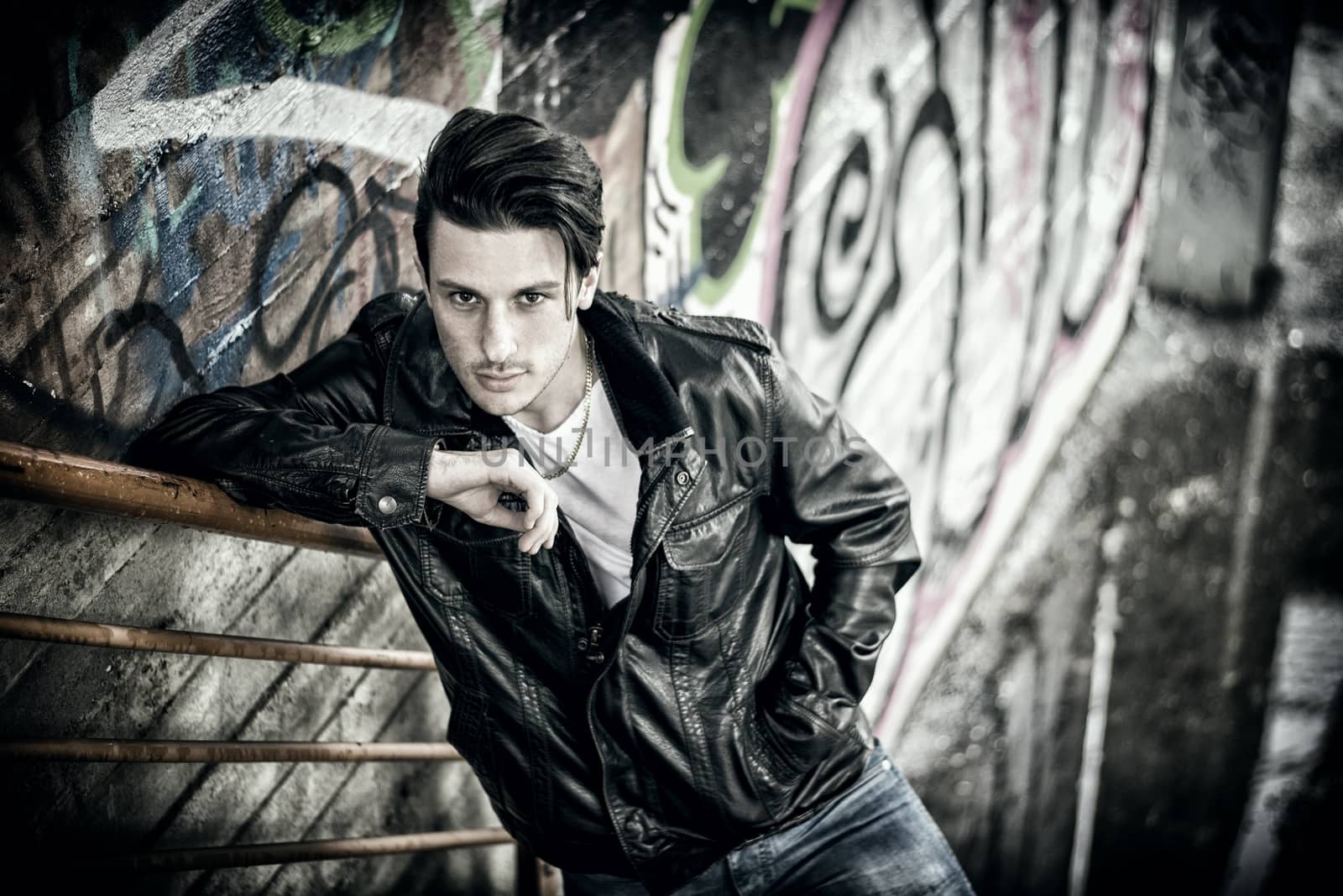 Young man standing outdoors in urban setting by artofphoto