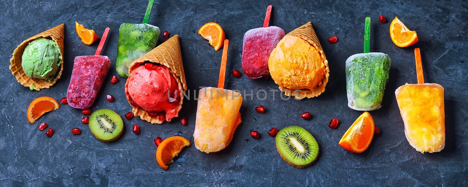 Summer ice cream assortment of fruit flavors with kiwi and pomegranate