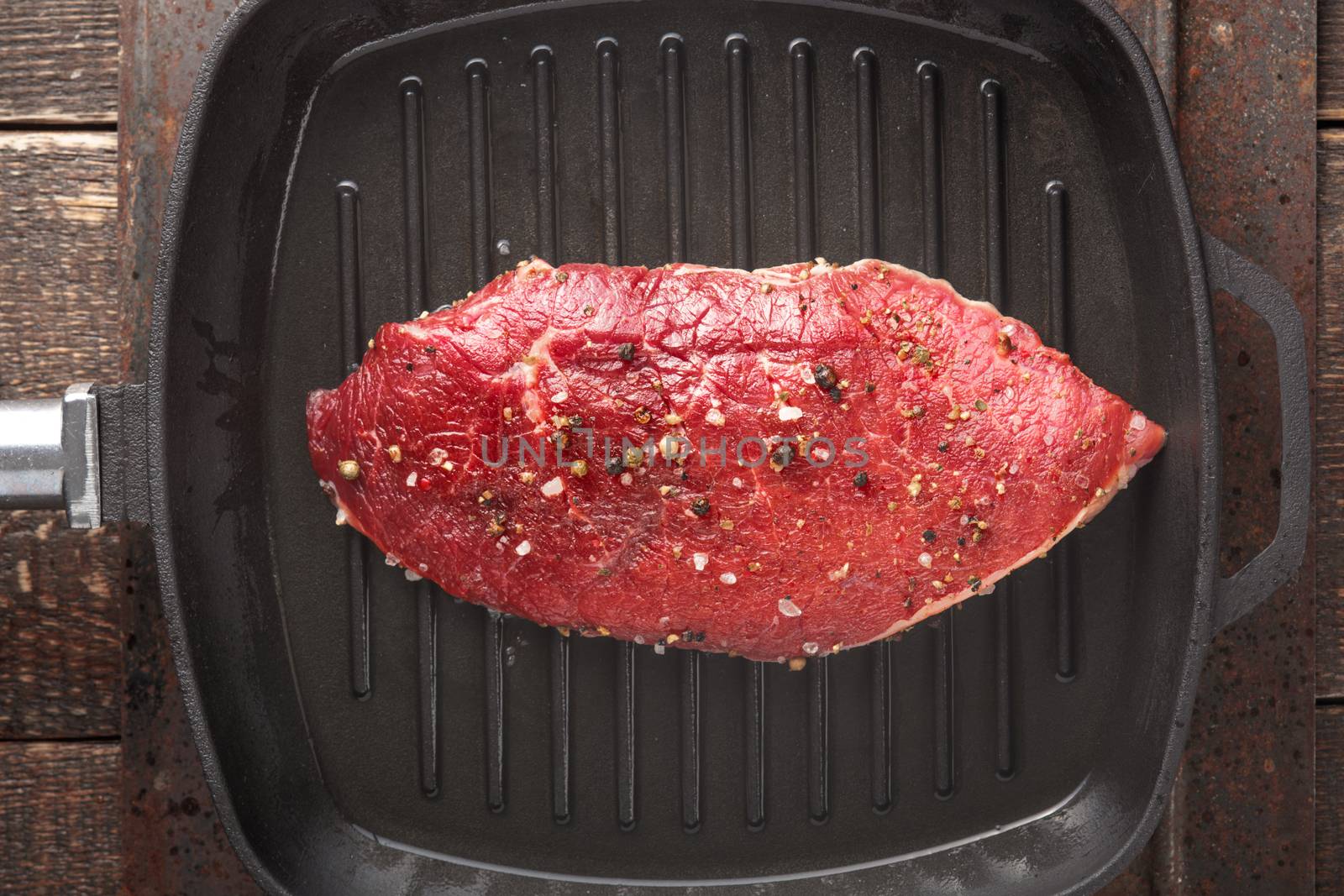 Raw beef steak on pan grill by Deniskarpenkov