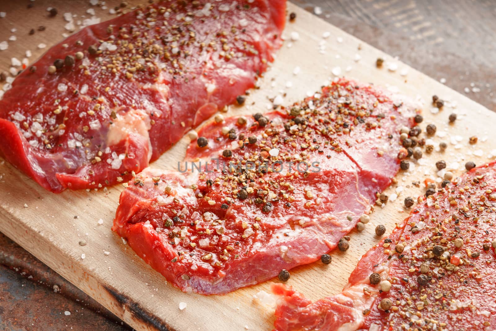 Fresh beef steak and spicel on the wooden board by Deniskarpenkov