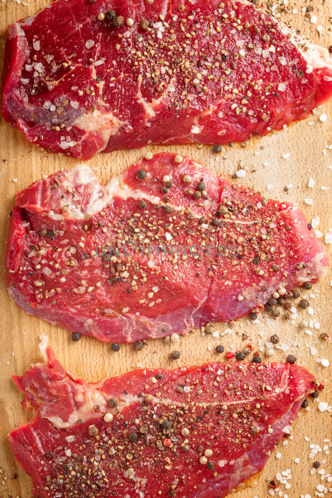 Fresh beef steak and spicel on cutting board by Deniskarpenkov