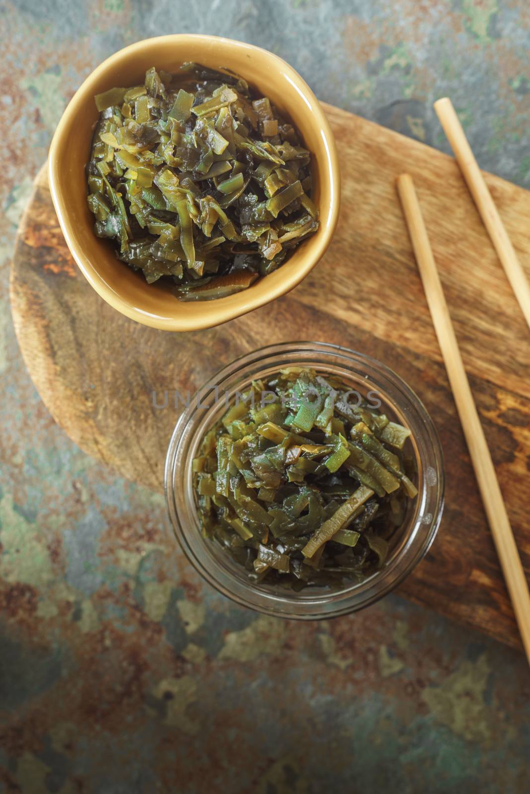 Seaweed in bowls on a wooden board on the table vertical