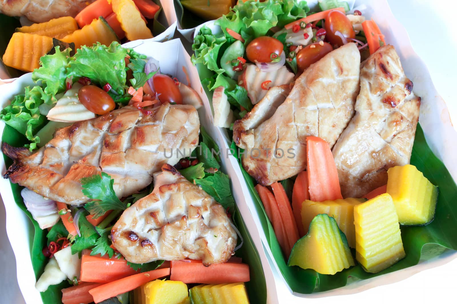 Grilled chicken steak with spices and vegetable paper tray vice banana leaves, Natural materials save the environment and Healthy diet meals.