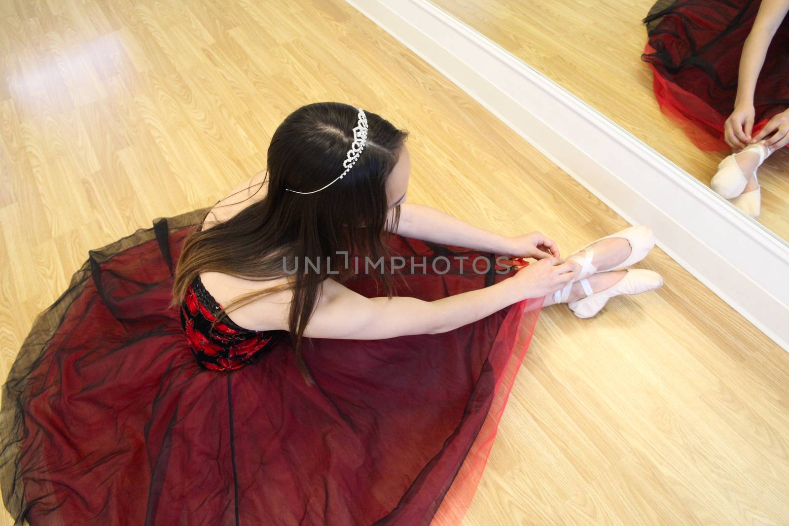Beautiful brunette teen dancer in a burgundy costume