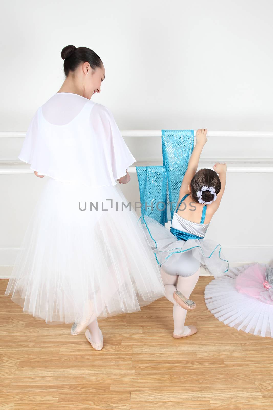 Teen dancer and toddler in costume at dance studio