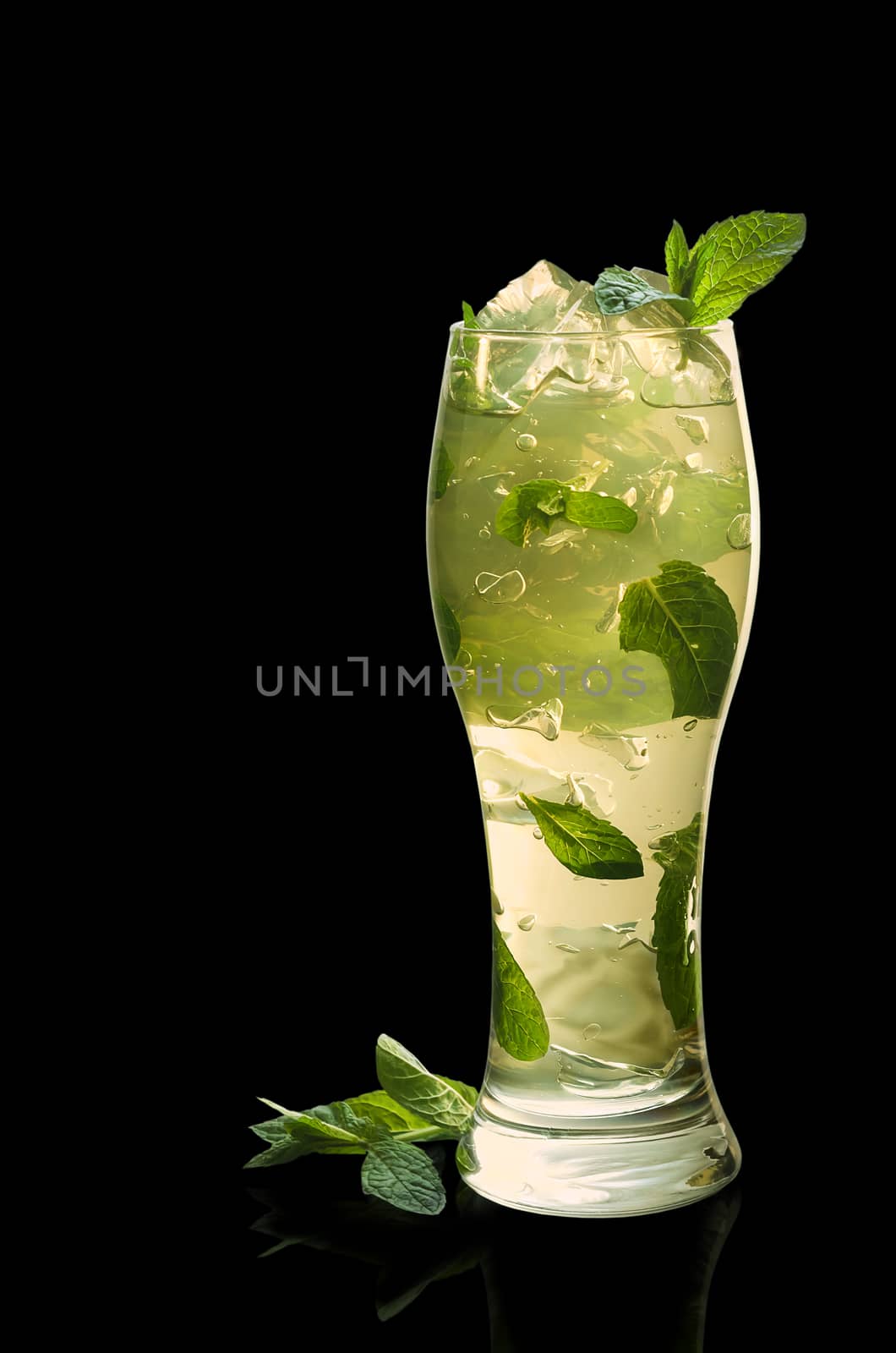 Mint jelly with leaves and ice on a black background.