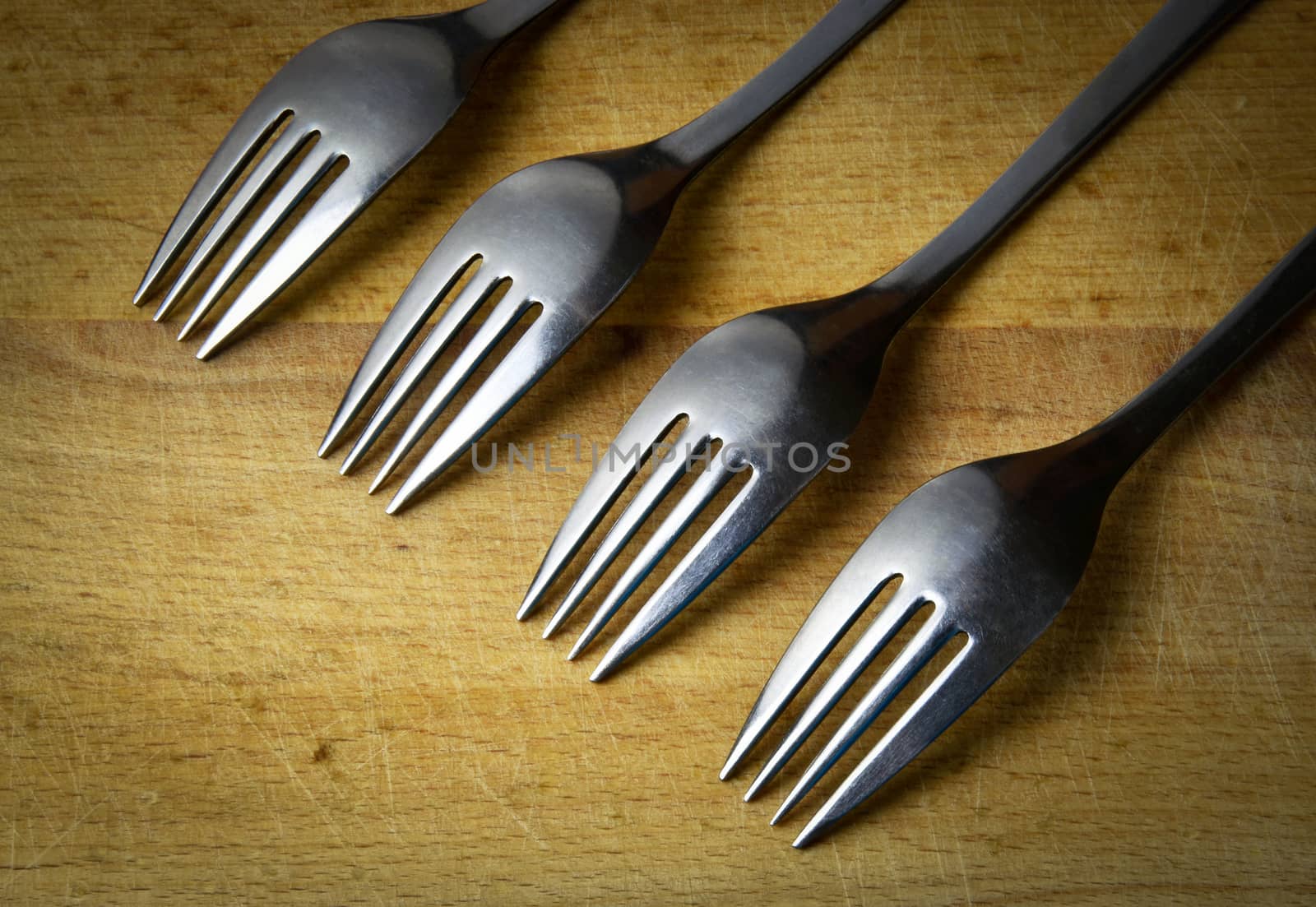 background four forks obliquely on wood