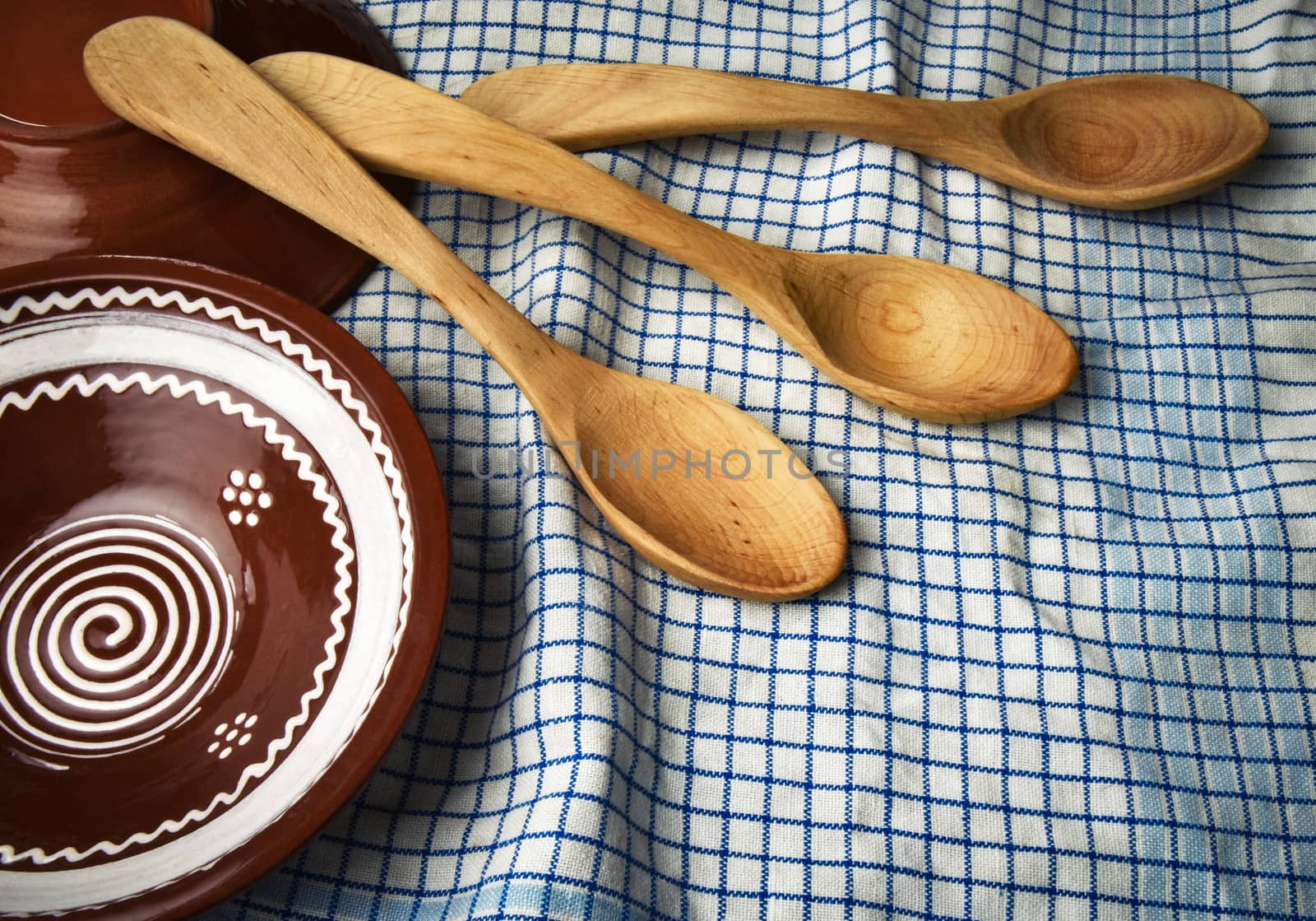 background traditional Slovak wooden spoon and a clay bowl