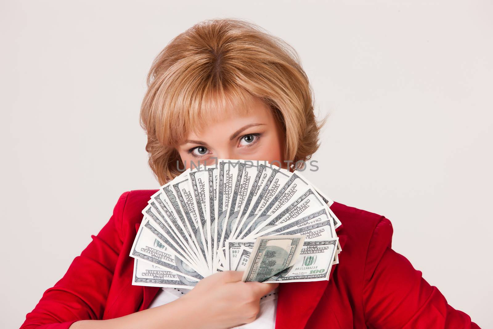 Young woman with a bunch of dollar banknotes