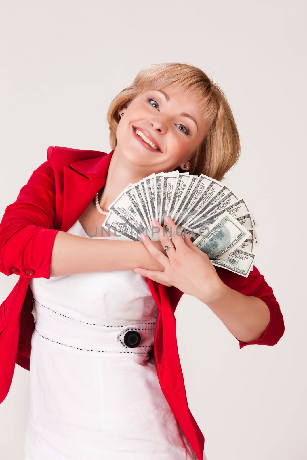 Young woman holding a fan of dollar banknotes