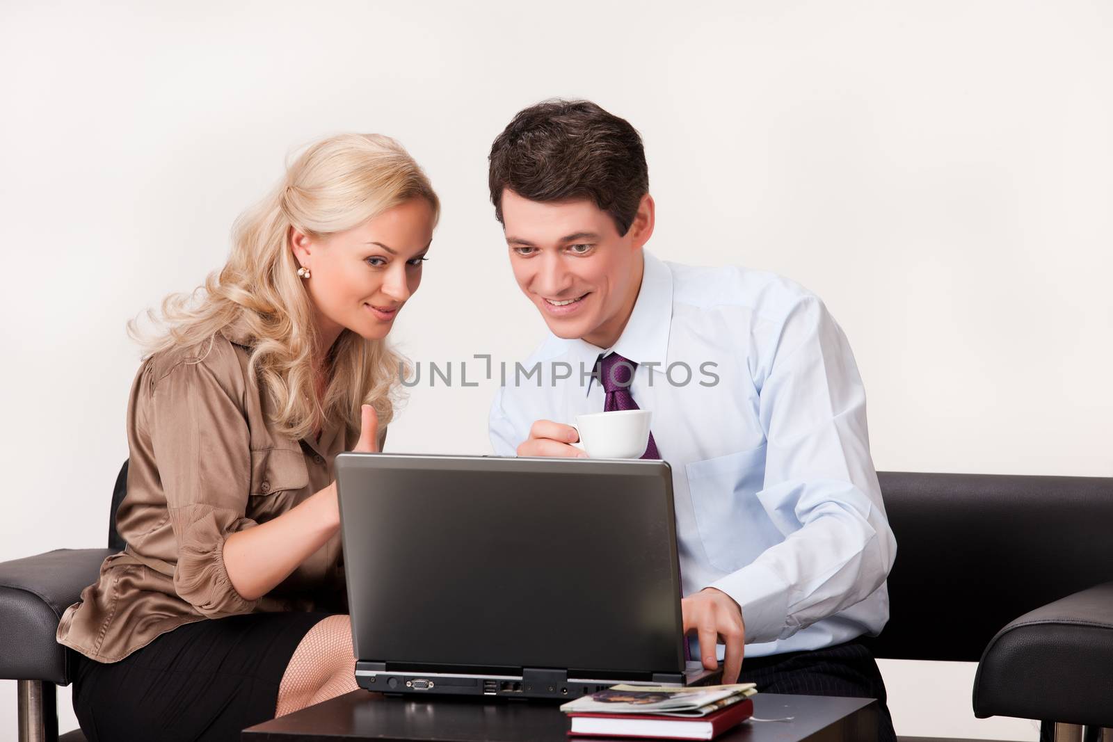 Young woman and man working at the notebook
