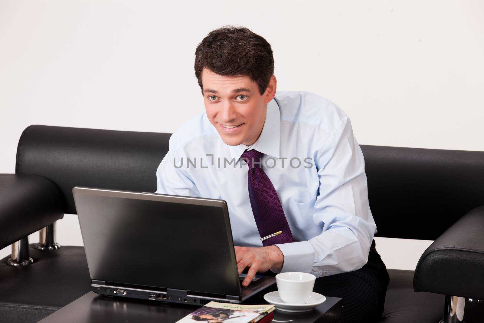 Young businessman in a suit on isolated background