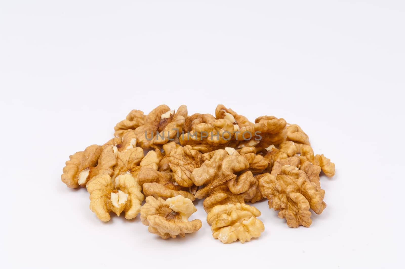 Pile walnut kernels on white background