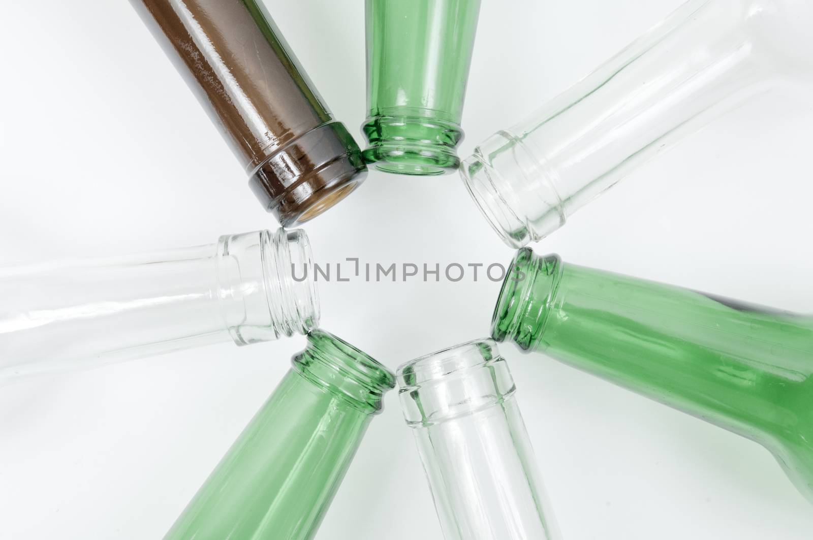 Empty glass bottles of mixed colors including green, clear white, brown