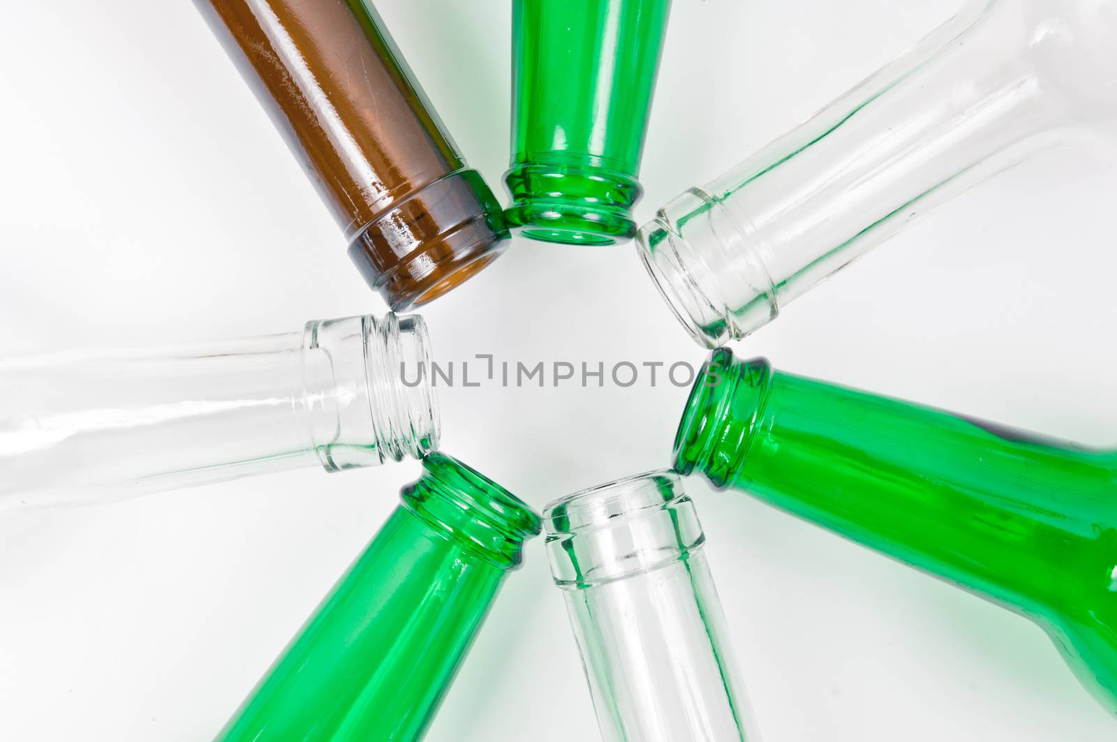 Empty glass bottles of mixed colors including green, clear white, brown