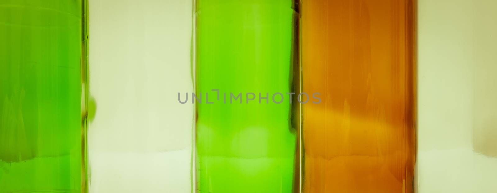 Empty glass bottles of mixed colors including green, clear white, brown