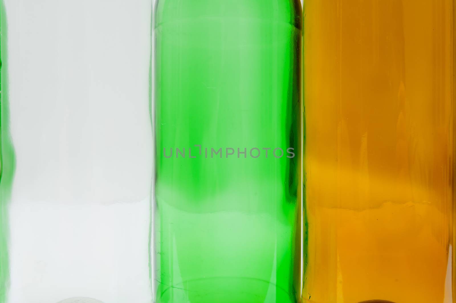 Empty glass bottles of mixed colors including green, clear white, brown