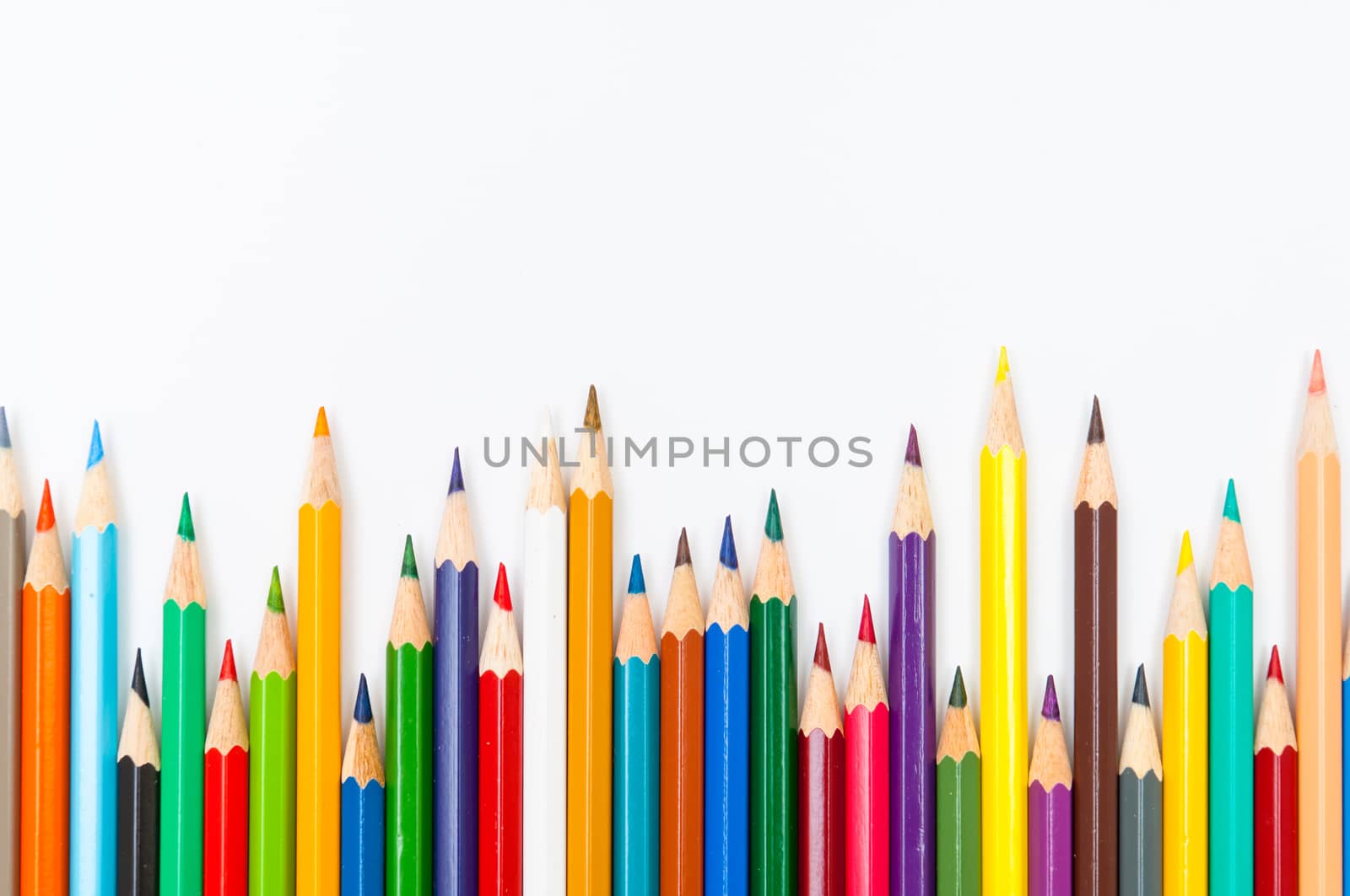 Pattern of color pencils isolated on white background close up