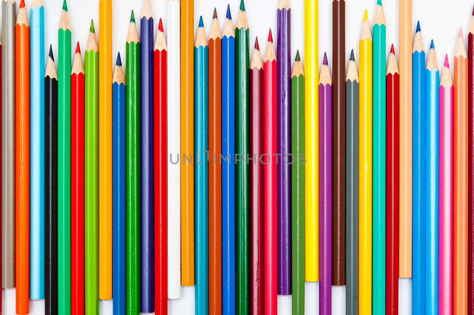 Pattern of color pencils isolated on white background close up