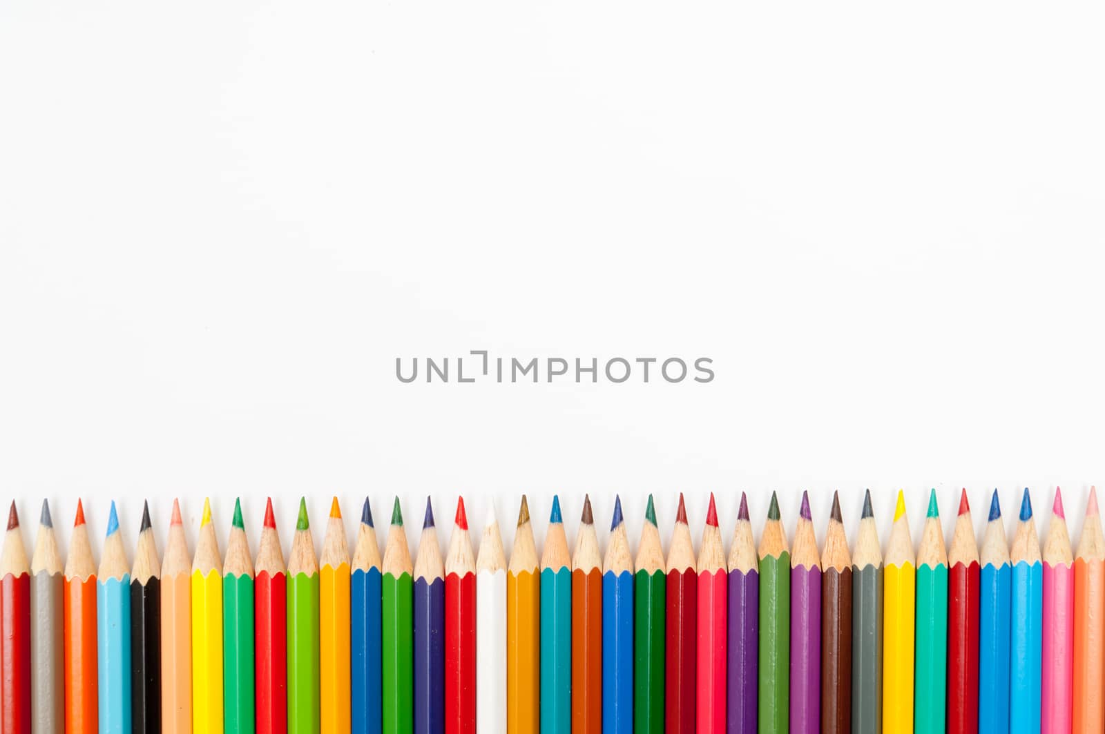 Pattern of color pencils isolated on white background close up