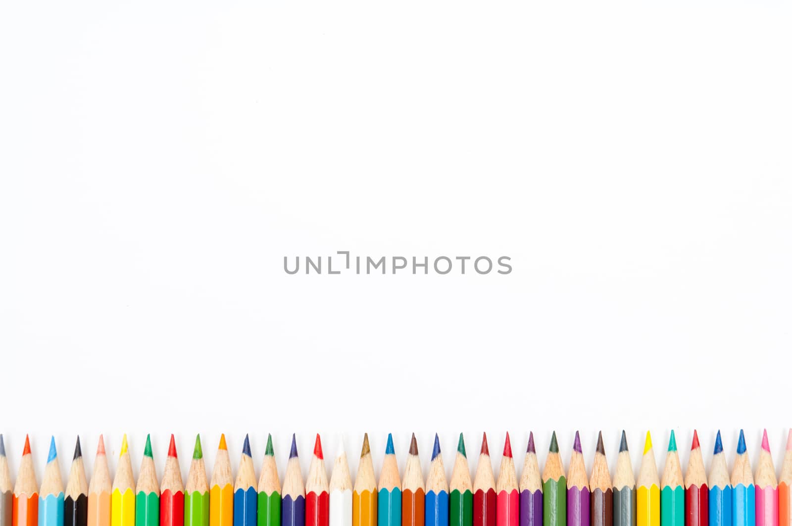 Pattern of color pencils isolated on white background close up