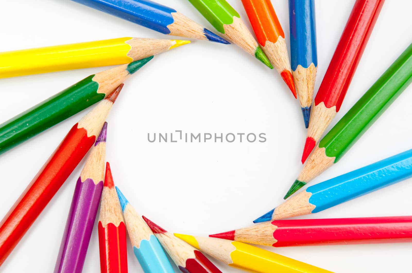 Pattern of color pencils isolated on white background close up