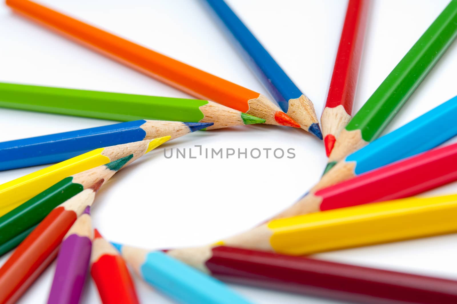 Pattern of color pencils isolated on white background close up