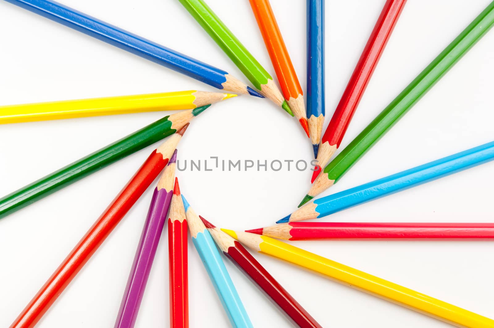 Pattern of color pencils isolated on white background close up