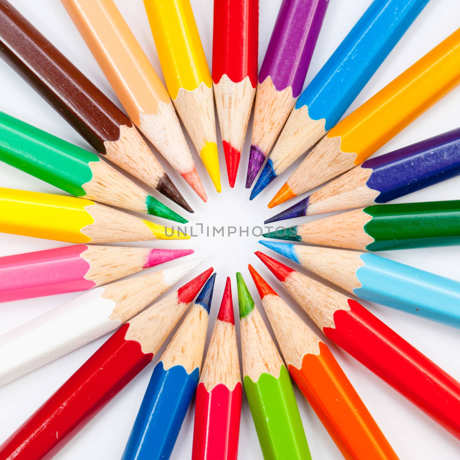 Pattern of color pencils isolated on white background close up