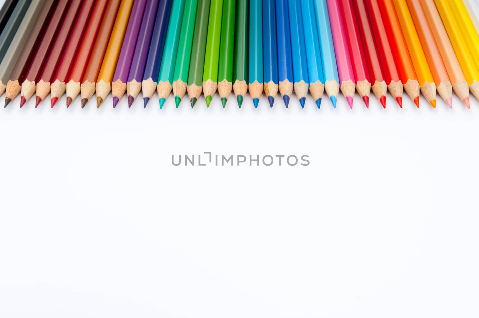 Pattern of color pencils isolated on white background close up