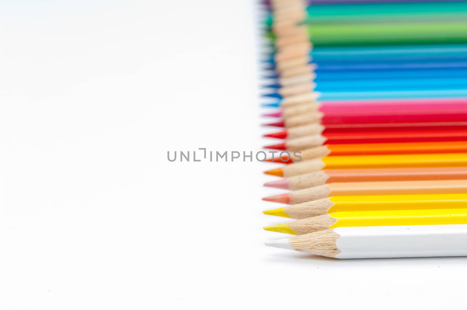 Pattern of color pencils isolated on white background close up