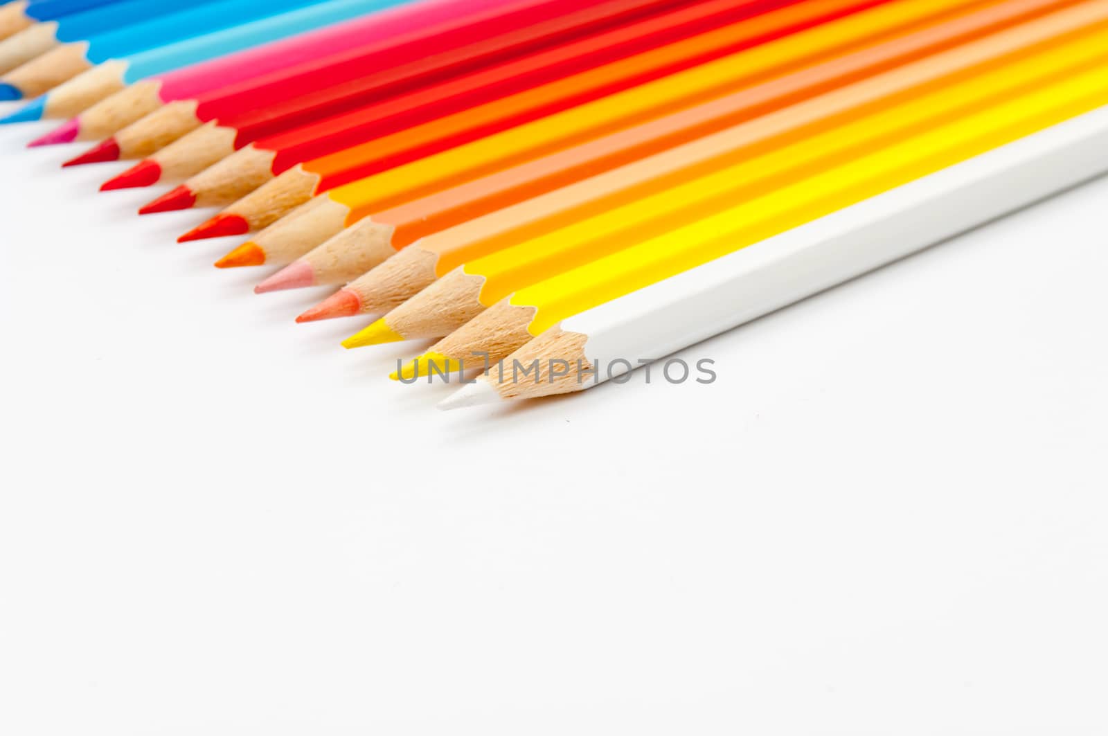 Pattern of color pencils isolated on white background close up